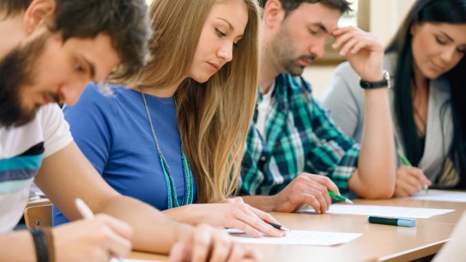 21875800 - young students having a test in a classroom