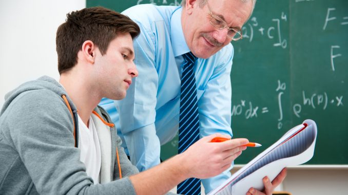 student with a teacher in classroom